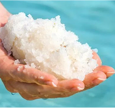 Unrefined ancient sea minerals held in two hands